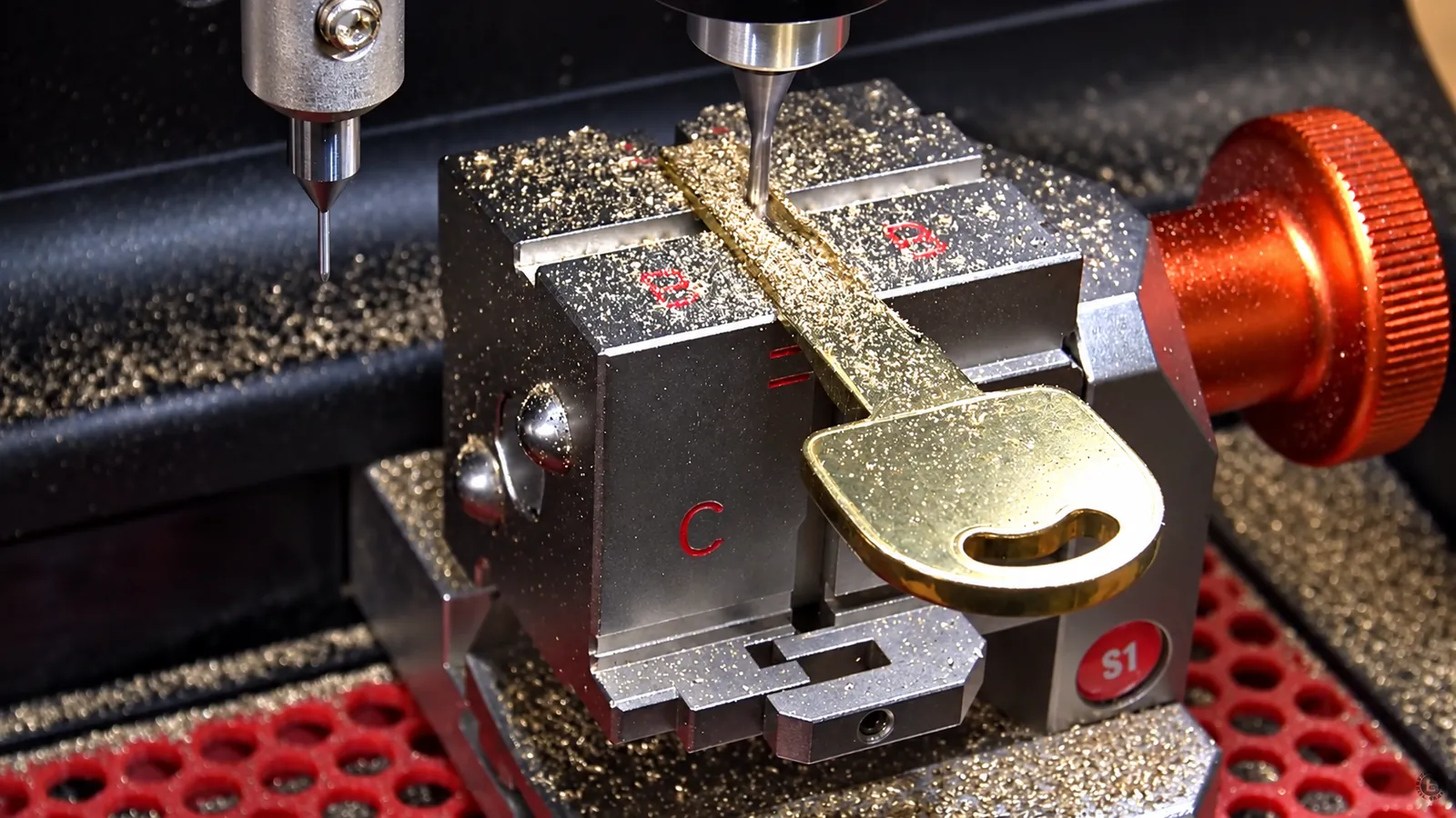Key cutting machine cutting a new car key at Jax Lockout Services